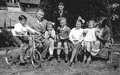 The Wine family and a friend in the 1940s, with David on his tricycle